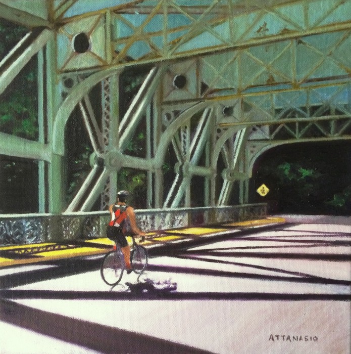 Bicyclist in sunshine crossing Falls Bridge over Schuylkill River, Philadelphia